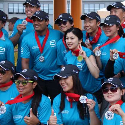  photo of: Employees winning 2nd place medals after competing in the Dragon Boat Race for Literacy.